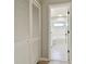 Hallway with a view to the bathroom featuring a walk-in shower and gray tile floors at 1701 62Nd S Ter, St Petersburg, FL 33712