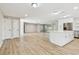 Modern kitchen with an island bar, stainless steel appliances, and an open layout to the living space at 1701 62Nd S Ter, St Petersburg, FL 33712