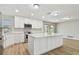 An open kitchen displays modern appliances, a center island with a stone countertop, and bright, natural light at 1701 62Nd S Ter, St Petersburg, FL 33712