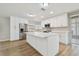 Bright, remodeled kitchen boasts stainless steel appliances, white cabinets, and a large center island with a marble countertop at 1701 62Nd S Ter, St Petersburg, FL 33712