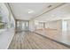 Open living room with light wood flooring, access to the kitchen, and several windows providing lots of natural light at 1701 62Nd S Ter, St Petersburg, FL 33712
