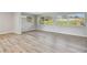 Bright living room featuring light wood floors, neutral walls, and lots of windows for natural light and outdoor views at 1701 62Nd S Ter, St Petersburg, FL 33712