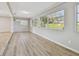 Bright living room with neutral walls, plank flooring, and several windows that provide natural light at 1701 62Nd S Ter, St Petersburg, FL 33712