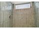 Stylish shower features green glossy tiles, shower head, and frosted window at 1701 62Nd S Ter, St Petersburg, FL 33712