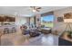Open-concept living room with plush seating, water views, stylish decor, and seamless transition to dining at 1703 Tahitian Sunrise Dr, Plant City, FL 33565