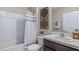 Well-lit bathroom featuring tile shower, a vanity with granite countertop, and decorative wall art at 1704 Tahitian Sunrise Dr, Plant City, FL 33565