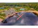 Aerial view of the lakefront community clubhouse with a dock, lake access, and recreational amenities at 18050 Cozumel Isle Dr, Tampa, FL 33647