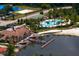 Aerial view featuring the community pool and clubhouse overlooking the lake and beach at 18050 Cozumel Isle Dr, Tampa, FL 33647