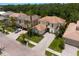 Stunning aerial view of a luxurious two-story home with a tile roof, beautiful landscaping, and a spacious driveway at 18050 Cozumel Isle Dr, Tampa, FL 33647