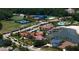 Aerial view of neighborhood with community lake, pool, clubhouse, and many amenities at 18050 Cozumel Isle Dr, Tampa, FL 33647
