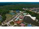High aerial view showcasing community amenities including a pool, tennis courts, and clubhouse at 18050 Cozumel Isle Dr, Tampa, FL 33647