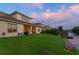 Beautiful backyard featuring a well-kept lawn that backs up to a peaceful lake with a private dock at 18050 Cozumel Isle Dr, Tampa, FL 33647