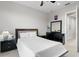 Bedroom featuring a black bed frame, dark wood furniture, and white walls at 18050 Cozumel Isle Dr, Tampa, FL 33647