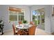 Breakfast nook with a glass table, wicker chairs, and a view of the backyard pond at 18050 Cozumel Isle Dr, Tampa, FL 33647