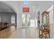 Elegant foyer with high ceilings, tile floors, and decorative glass doors leading to the home at 18050 Cozumel Isle Dr, Tampa, FL 33647