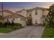 Inviting home with a paver driveway, well-manicured landscaping, and a two-car garage at 18050 Cozumel Isle Dr, Tampa, FL 33647