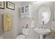 Half bathroom with a pedestal sink, toilet, and cabinet for storage at 18050 Cozumel Isle Dr, Tampa, FL 33647