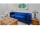 Comfortable living room showcasing a blue couch, wooden coffee table, and sports memorabilia art at 18050 Cozumel Isle Dr, Tampa, FL 33647