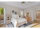 Bright main bedroom with four-poster bed, ceiling fan, and ensuite bathroom at 18050 Cozumel Isle Dr, Tampa, FL 33647
