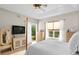Light and airy main bedroom with pond views, a tray ceiling, and light colored wood floors at 18050 Cozumel Isle Dr, Tampa, FL 33647