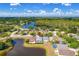 An aerial view shows a lovely neighborhood with multiple ponds, lush trees, and well-maintained homes with screened-in pools at 19309 Garden Quilt Cir, Lutz, FL 33558