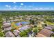 Enjoy this aerial view of home with a pond, lush landscaping, and blue skies that highlight this wonderful neighborhood at 19309 Garden Quilt Cir, Lutz, FL 33558