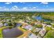 A wide aerial view reveals a Gathering-friendly neighborhood with ponds, lush greenery, and well-kept homes with screened pools at 19309 Garden Quilt Cir, Lutz, FL 33558