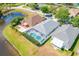 Aerial view of houses on the water, showcasing in-ground pools and screened in lanai; perfect for entertaining and relaxation at 19309 Garden Quilt Cir, Lutz, FL 33558