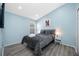 Stylish bedroom featuring a comfortable bed, side tables, and a colorful painting at 19309 Garden Quilt Cir, Lutz, FL 33558