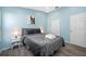 This cozy bedroom features calming blue walls and a soft, inviting bed with plush pillows and a stylish gray quilt at 19309 Garden Quilt Cir, Lutz, FL 33558