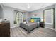 Cozy bedroom featuring a large window, soothing gray walls, and stylish decor at 19309 Garden Quilt Cir, Lutz, FL 33558