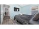 Bright bedroom showcasing wood-look floors, and a modern TV at 19309 Garden Quilt Cir, Lutz, FL 33558