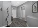 Welcoming entryway with elegant gray walls, modern black accents, wood-look floors, and views of the front door and hallways at 19309 Garden Quilt Cir, Lutz, FL 33558