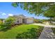 Landscaped front yard of a well-maintained home with a charming garden and a two-car garage at 19309 Garden Quilt Cir, Lutz, FL 33558