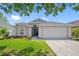 Charming single-Gathering home with a well-manicured lawn and a two-car garage on a sunny day at 19309 Garden Quilt Cir, Lutz, FL 33558