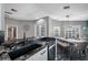 Open-concept kitchen overlooking dining area, featuring granite countertops, stainless steel appliances, and inviting atmosphere at 19309 Garden Quilt Cir, Lutz, FL 33558