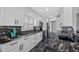 Modern kitchen with sleek white cabinets, black granite countertops, stainless steel appliances, and contemporary finishes at 19309 Garden Quilt Cir, Lutz, FL 33558