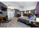 Large main bedroom with a ceiling fan, wood-look flooring, and TV at 19309 Garden Quilt Cir, Lutz, FL 33558