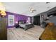 This main bedroom features wood-look floors, stylish grey and purple decor, and a ceiling fan at 19309 Garden Quilt Cir, Lutz, FL 33558
