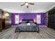 The main bedroom boasts wood-look floors, ample space, and a ceiling fan at 19309 Garden Quilt Cir, Lutz, FL 33558