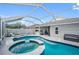Screened-in pool with a connected spa and plenty of patio space at 19309 Garden Quilt Cir, Lutz, FL 33558