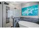 Walk-in shower with textured wall and rainfall shower head at 19309 Garden Quilt Cir, Lutz, FL 33558