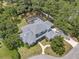 Aerial view of home showing the expansive roofline, backyard, and screened pool at 2011 Water Wheel Ct, Dunedin, FL 34698