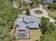 Aerial shot of an estate home with backyard screened pool in a lush, mature neighborhood at 2011 Water Wheel Ct, Dunedin, FL 34698