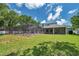 Expansive backyard featuring a screened pool, patio, and manicured lawn at 2011 Water Wheel Ct, Dunedin, FL 34698