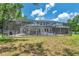 Spacious backyard showcasing a screened pool area, perfect for outdoor entertaining and relaxation at 2011 Water Wheel Ct, Dunedin, FL 34698