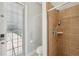 Tiled walk-in shower in bathroom with glass door and natural light at 2011 Water Wheel Ct, Dunedin, FL 34698