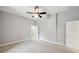 Minimalist bedroom showcasing neutral walls and a ceiling fan, creating a versatile and serene living space at 2011 Water Wheel Ct, Dunedin, FL 34698