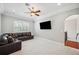 Bonus room featuring recessed lights, crown molding, plantation shutters, and a leather sectional at 2011 Water Wheel Ct, Dunedin, FL 34698
