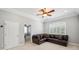 Bonus room with crown molding, a ceiling fan, plantation shutters, and a leather sectional at 2011 Water Wheel Ct, Dunedin, FL 34698